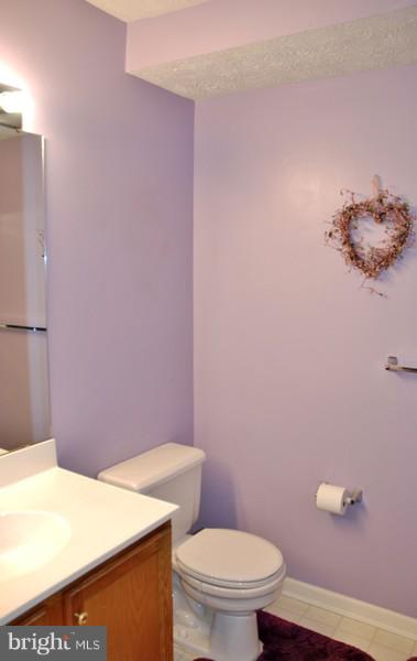 4868 Shellbark Road Owings Mills, MD 21117 - Photo 16 of 23 a bathroom with a sink a toilet and vanity