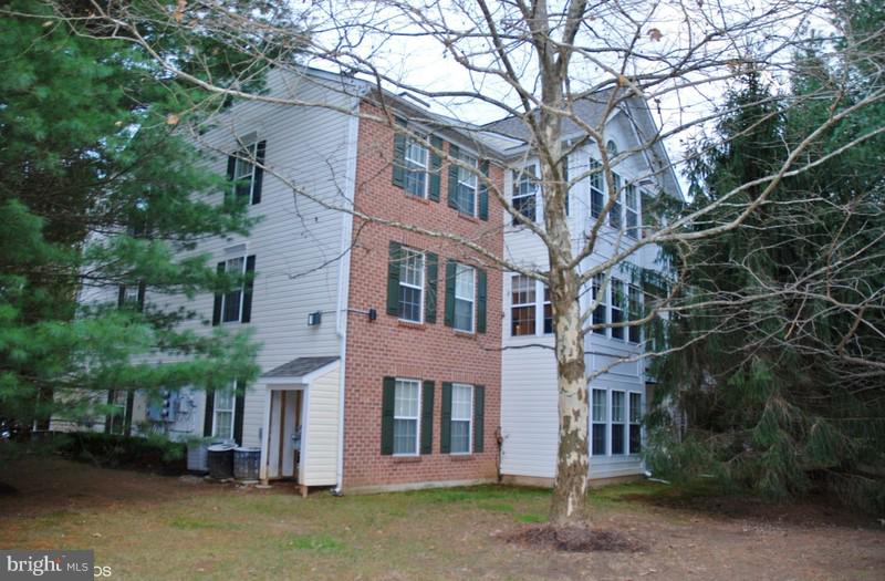 4868 Shellbark Road Owings Mills, MD 21117 - Photo 4 of 23 a view of a brick building next to a road and large trees