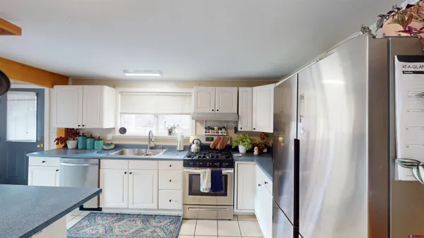 a kitchen with stainless steel appliances a refrigerator sink and cabinets
