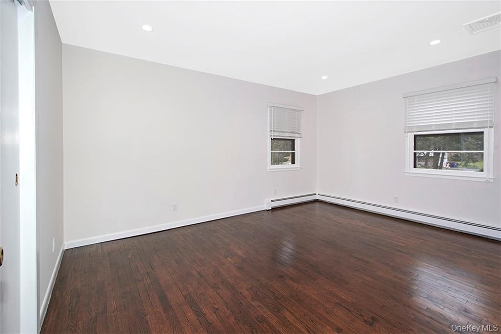 74 Edgewood Road Ossining, NY 10562 - Photo 14 of 29 Bedroom featuring dark wood-finish flooring, windows and recessed ceiling lighting
