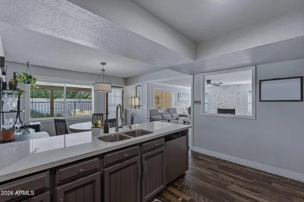 a kitchen with stainless steel appliances a sink and a refrigerator