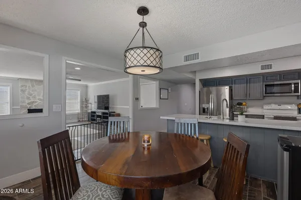 a view of a workspace with furniture and a chandelier fan