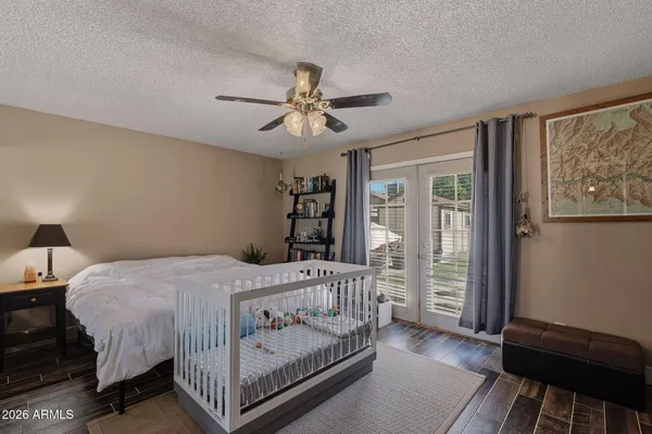 a bedroom with a bed and a flat screen tv