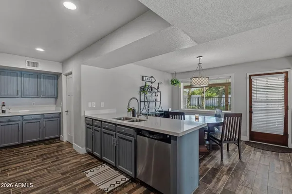 a kitchen with stainless steel appliances a stove microwave and sink