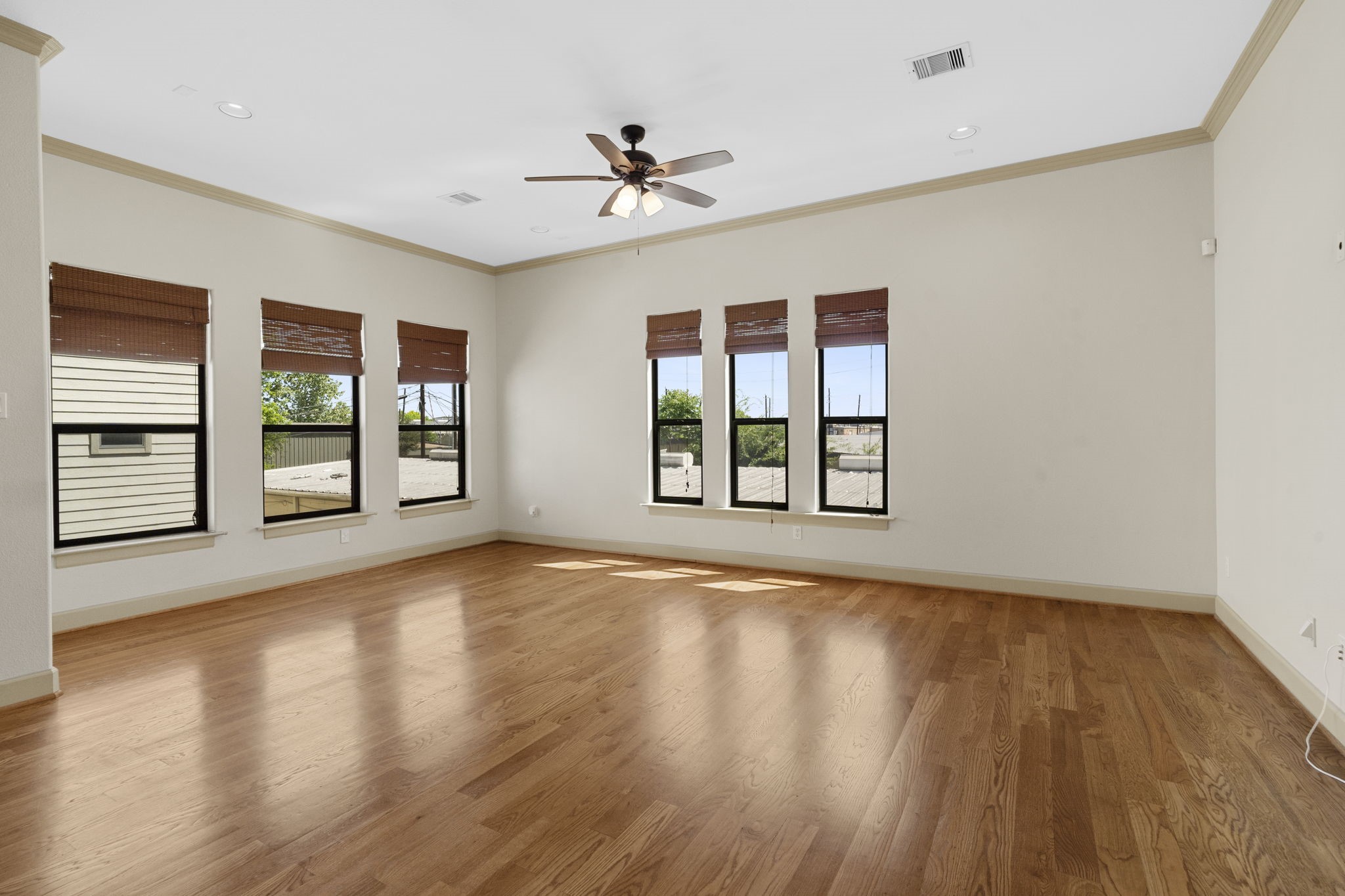 1218 Sandman Street Houston, TX 77007 - Photo 11 of 38 a view of an empty room with a window and wooden floor
