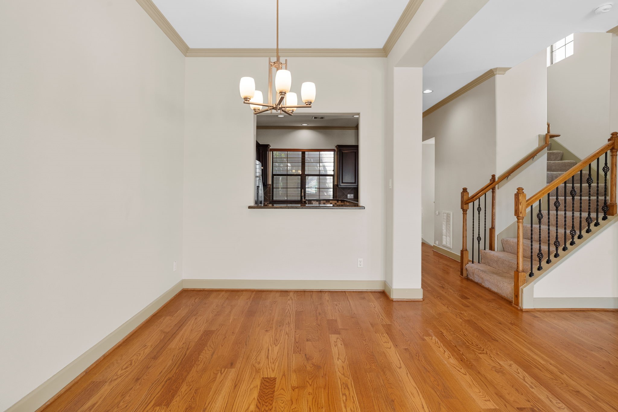 1218 Sandman Street Houston, TX 77007 - Photo 14 of 38 a view of a room with wooden floor staircase and a chandelier