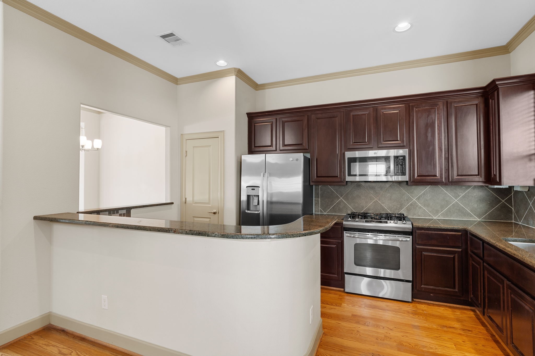 1218 Sandman Street Houston, TX 77007 - Photo 16 of 38 a kitchen with stainless steel appliances granite countertop a stove a sink and a microwave