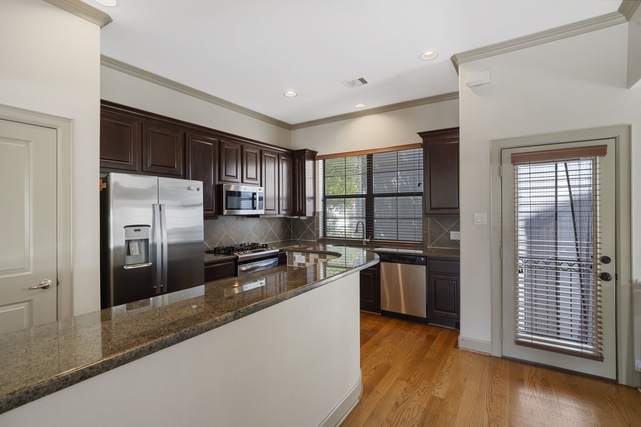 1218 Sandman Street Houston, TX 77007 - Photo 18 of 38 a kitchen with stainless steel appliances granite countertop a refrigerator a stove and a sink