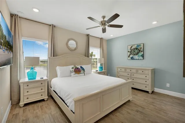 a bedroom with a bed and a chandelier