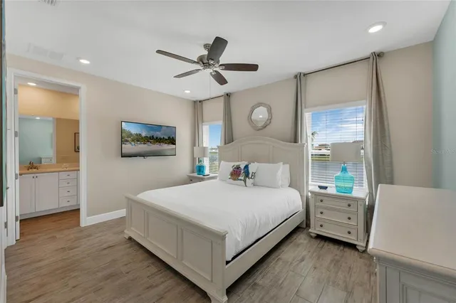 a bedroom with a bed and a chandelier