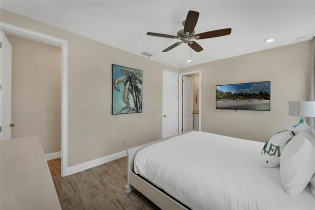 a bedroom with a large bed and a chandelier
