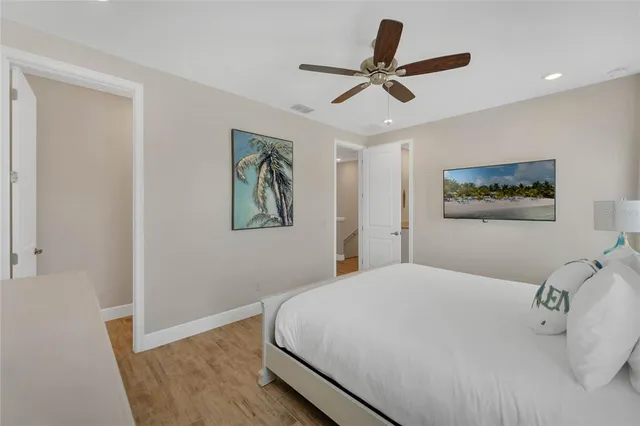 a bedroom with a large bed and a chandelier