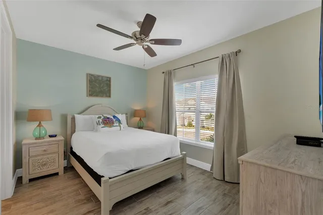 a bedroom with a bed a dresser and a window