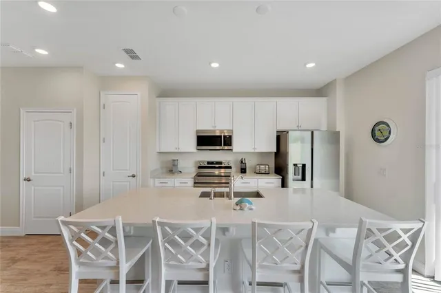 a kitchen with stainless steel appliances a refrigerator and a stove top oven