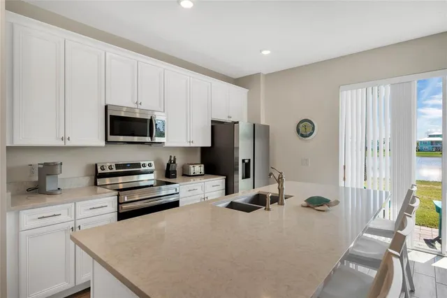 a kitchen with a sink a stove and refrigerator