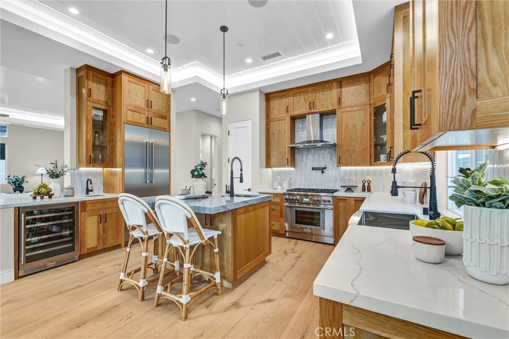 2016 Farrell Avenue, Unit B Redondo Beach, CA 90278 - Photo 10 of 51 a kitchen with stainless steel appliances granite countertop a stove top oven a sink a dining table and chairs with wooden floor