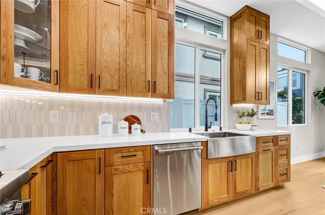 a kitchen with stainless steel appliances a sink and cabinets