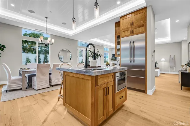 a kitchen with stainless steel appliances granite countertop a sink and a refrigerator