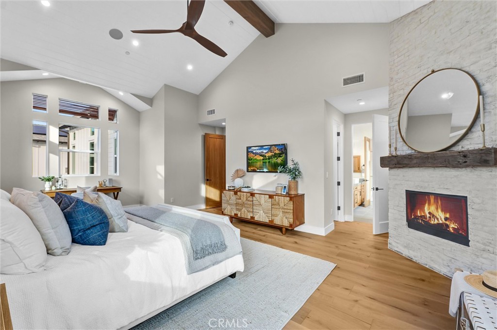 2016 Farrell Avenue, Unit B Redondo Beach, CA 90278 - Photo 24 of 51 a spacious bedroom with a bed a fireplace and a chandelier