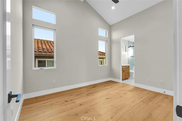 an empty room with windows and closet