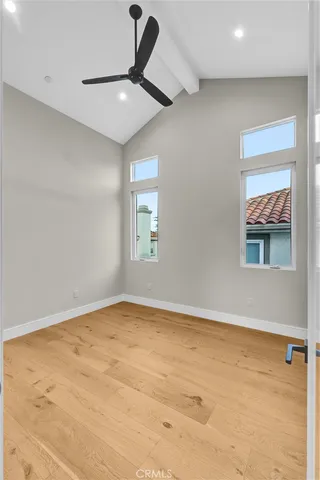 an empty room with a ceiling fan and window