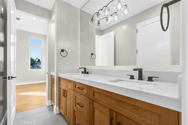 a bathroom with a double vanity sink a mirror and shower