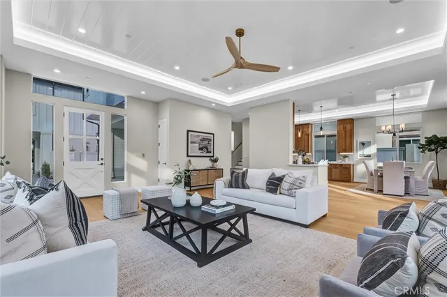 a living room with furniture and a view of kitchen