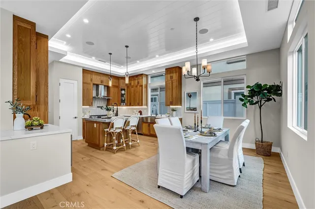a dining room with furniture window and wooden floor