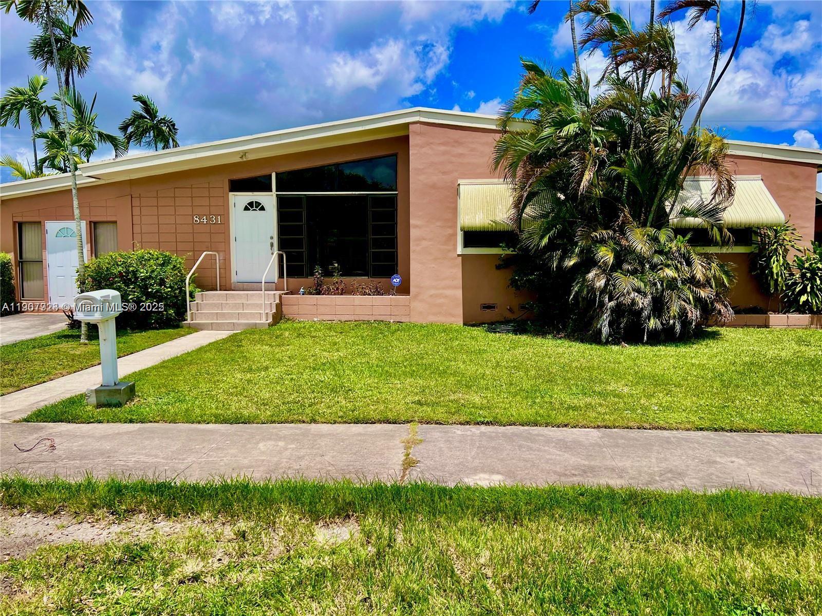 a view of a house with a yard and plants