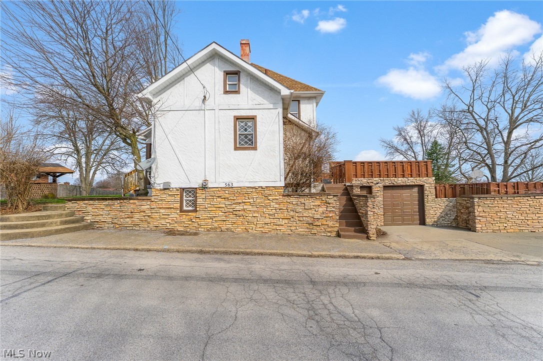 563 Geneva Avenue Struthers, OH 44471 - Photo 29 of 31 View of front of house featuring a chimney and concrete driveway