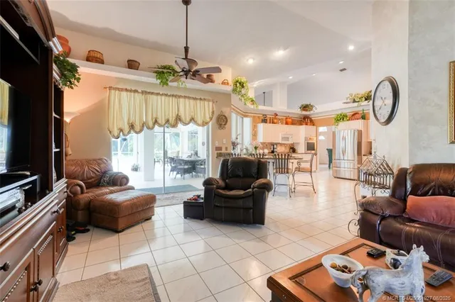 a living room with furniture a flat screen tv and a large window