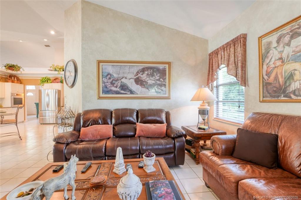 1171 Southeast Buttonwood Circle Stuart, FL 34997 - Photo 16 of 36 a living room with furniture and a large window
