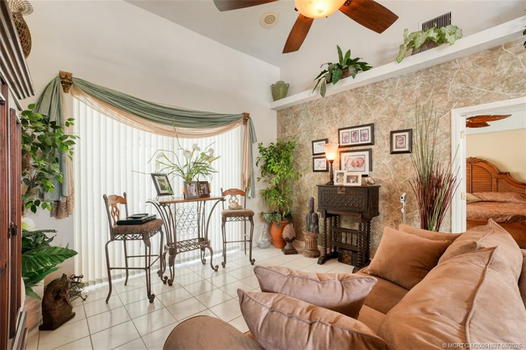 1171 Southeast Buttonwood Circle Stuart, FL 34997 - Photo 20 of 36 a living room with furniture and a large window