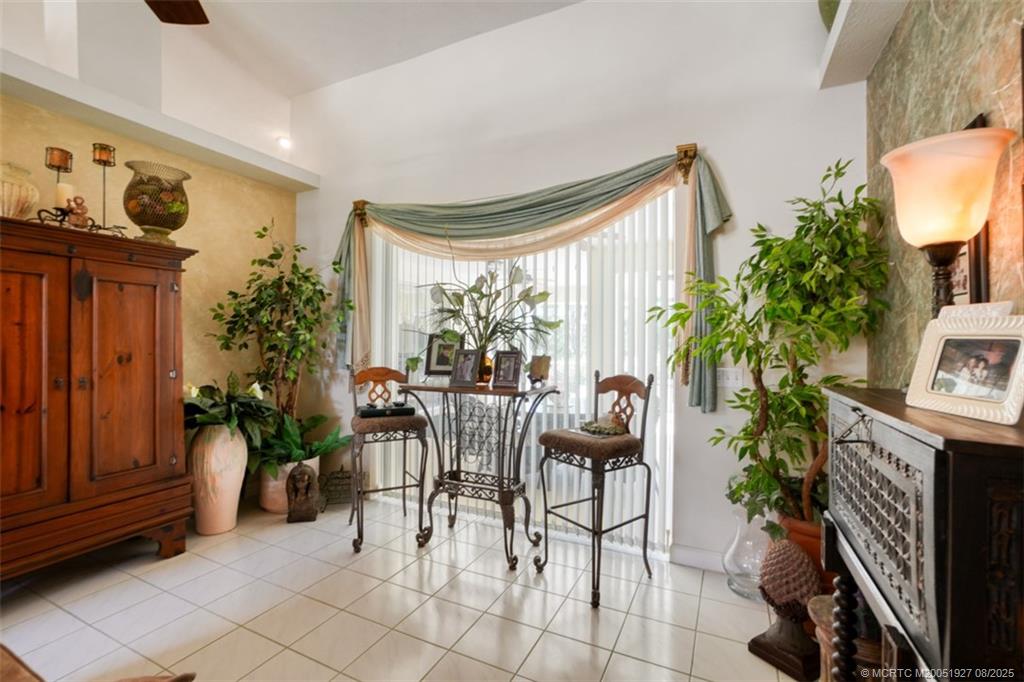 1171 Southeast Buttonwood Circle Stuart, FL 34997 - Photo 21 of 36 a view of a livingroom with furniture and a potted plant