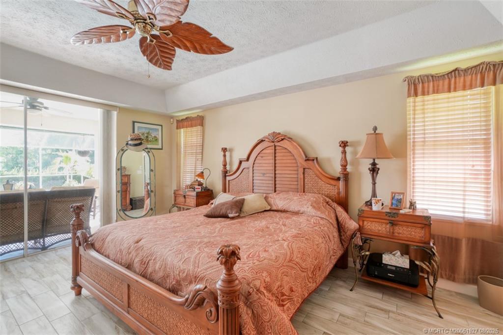 1171 Southeast Buttonwood Circle Stuart, FL 34997 - Photo 26 of 36 a bedroom with a bed and a large window