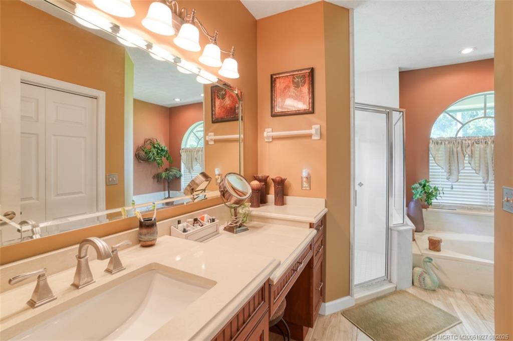 1171 Southeast Buttonwood Circle Stuart, FL 34997 - Photo 27 of 36 a bathroom with a granite countertop sink and a mirror