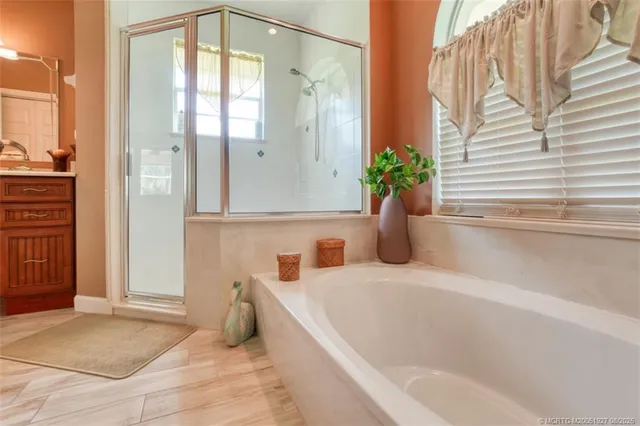 a bathroom with a tub sink and mirror