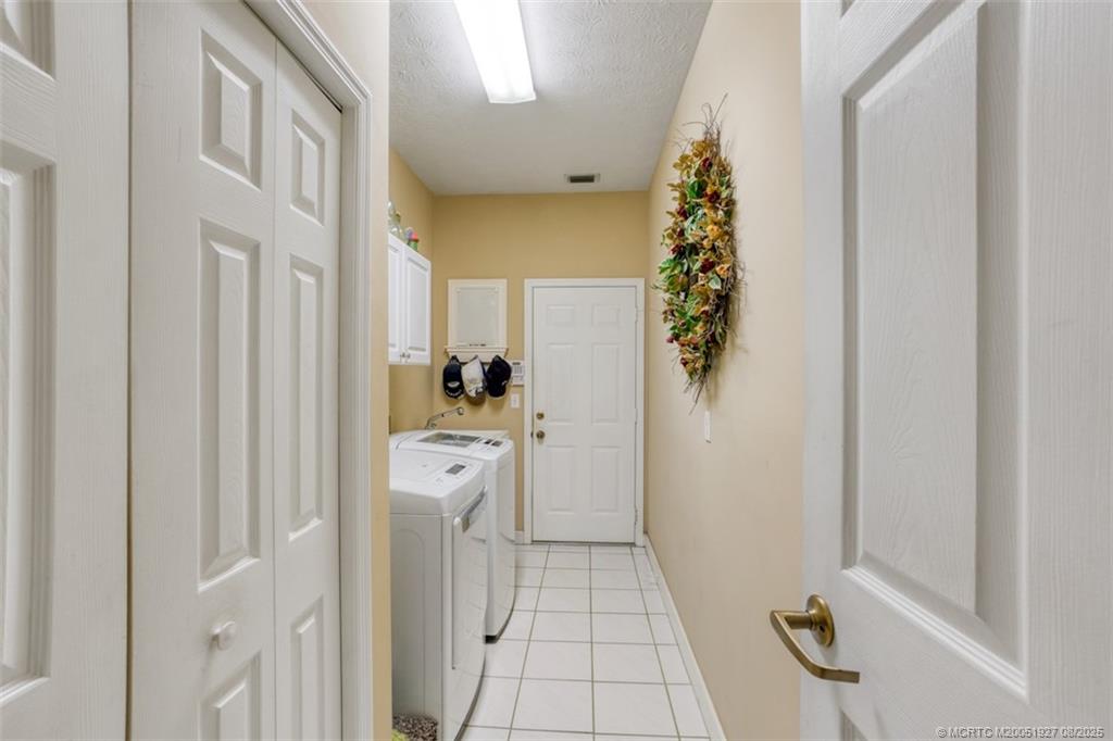 1171 Southeast Buttonwood Circle Stuart, FL 34997 - Photo 34 of 36 a room with a washer and dryer
