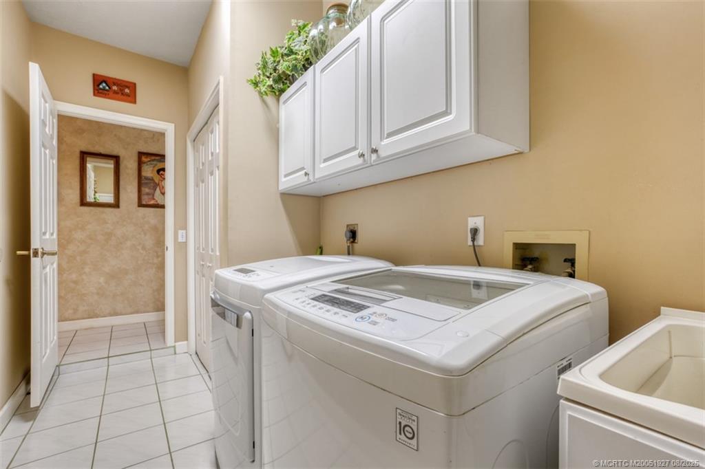 1171 Southeast Buttonwood Circle Stuart, FL 34997 - Photo 35 of 36 a utility room with dryer and washer