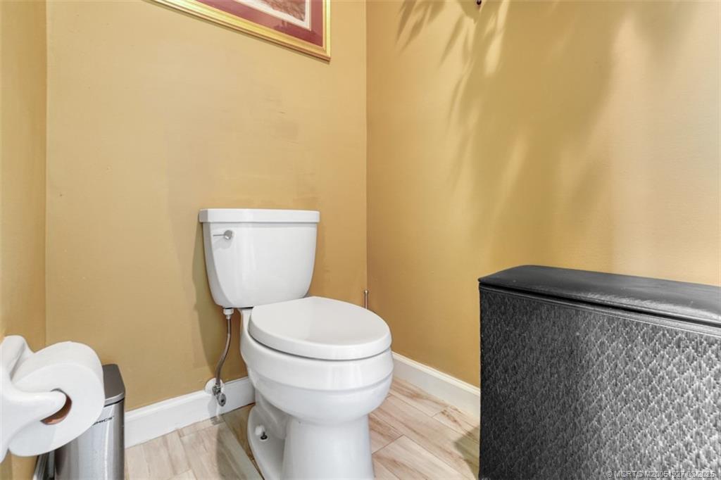 1171 Southeast Buttonwood Circle Stuart, FL 34997 - Photo 36 of 36 a bathroom with a toilet and a sink