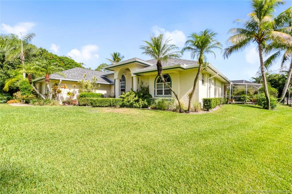 1171 Southeast Buttonwood Circle Stuart, FL 34997 - Photo 4 of 36 a view of house with outdoor space and swimming pool