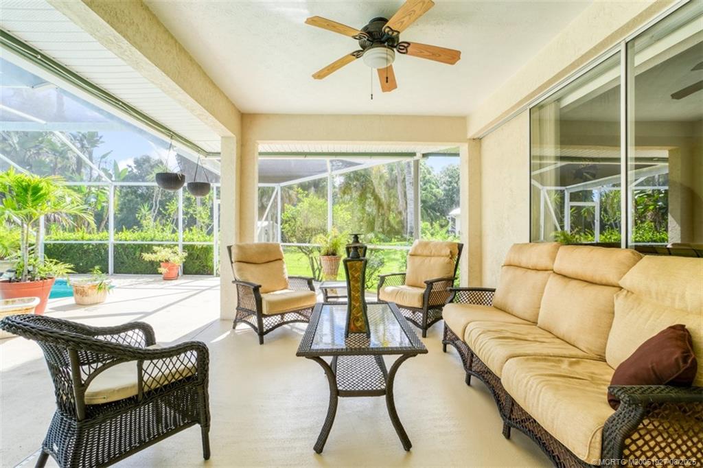 1171 Southeast Buttonwood Circle Stuart, FL 34997 - Photo 8 of 36 a living room with furniture and a large window