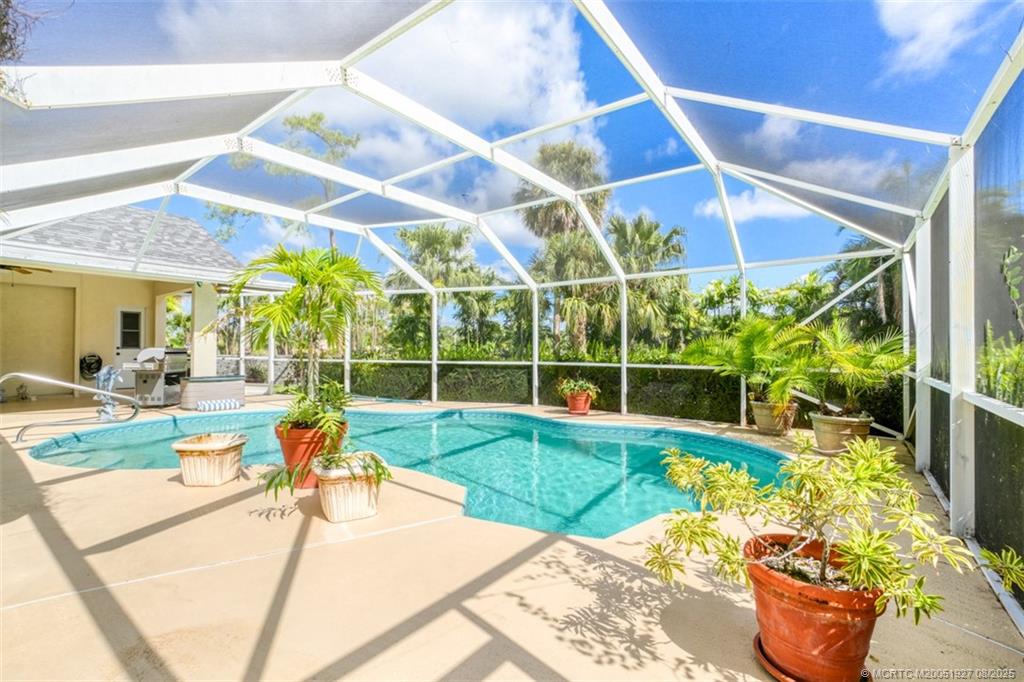 1171 Southeast Buttonwood Circle Stuart, FL 34997 - Photo 9 of 36 a view of a backyard with swimming pool