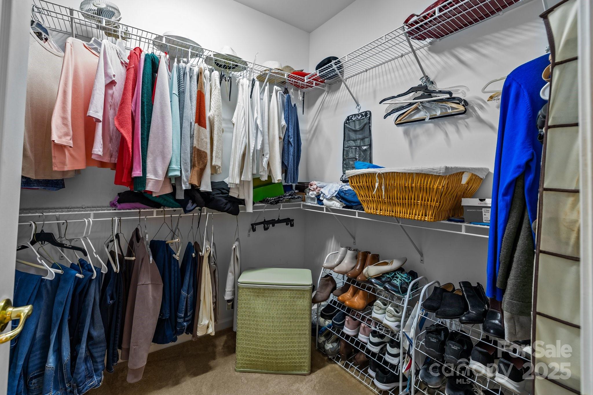 1668 Onyx Ridge, Unit 116 Fort Mill, SC 29708 - Photo 13 of 20 a view of walk in closet with clothes and shoes