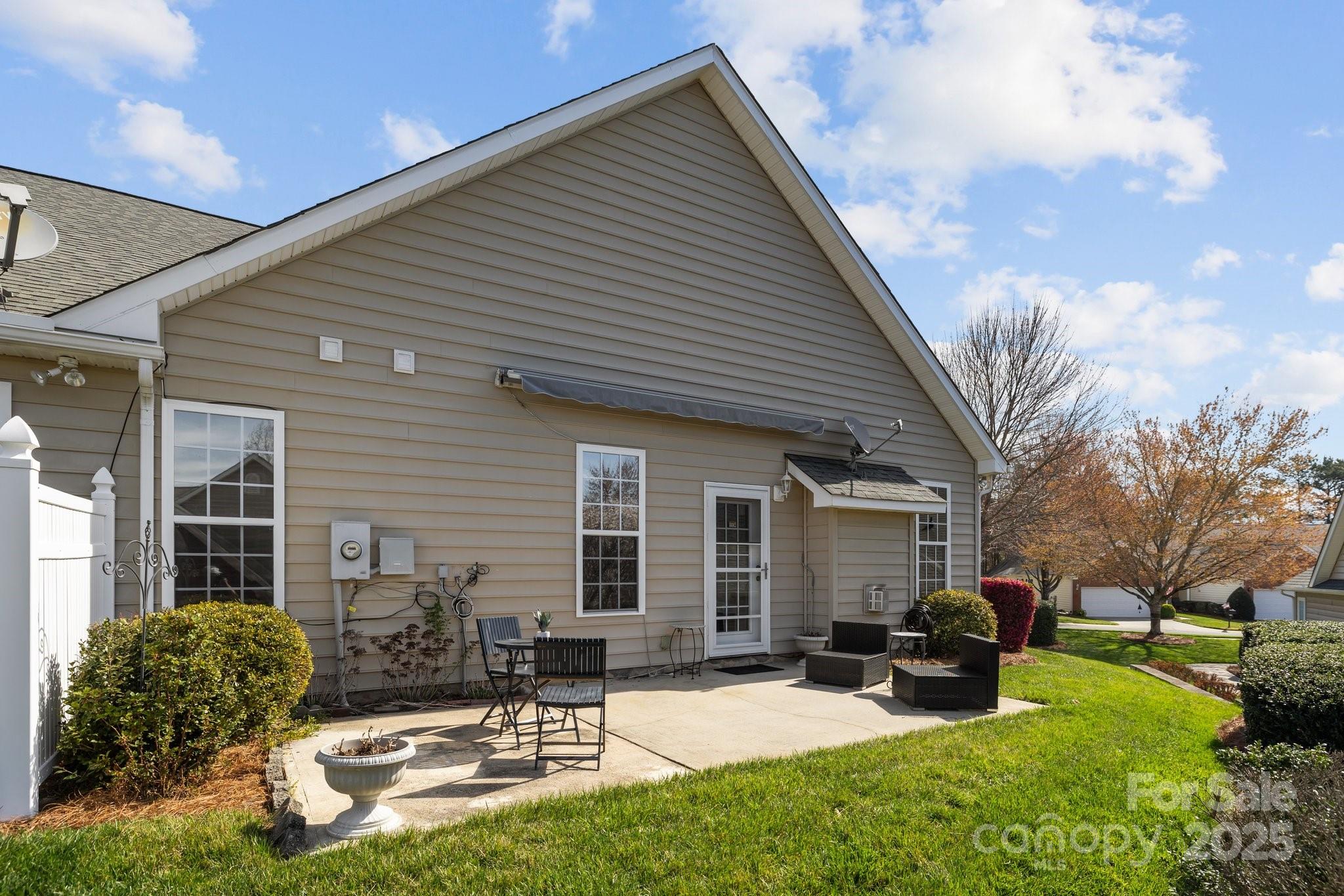 1668 Onyx Ridge, Unit 116 Fort Mill, SC 29708 - Photo 18 of 20 a view of a house with backyard porch and sitting area