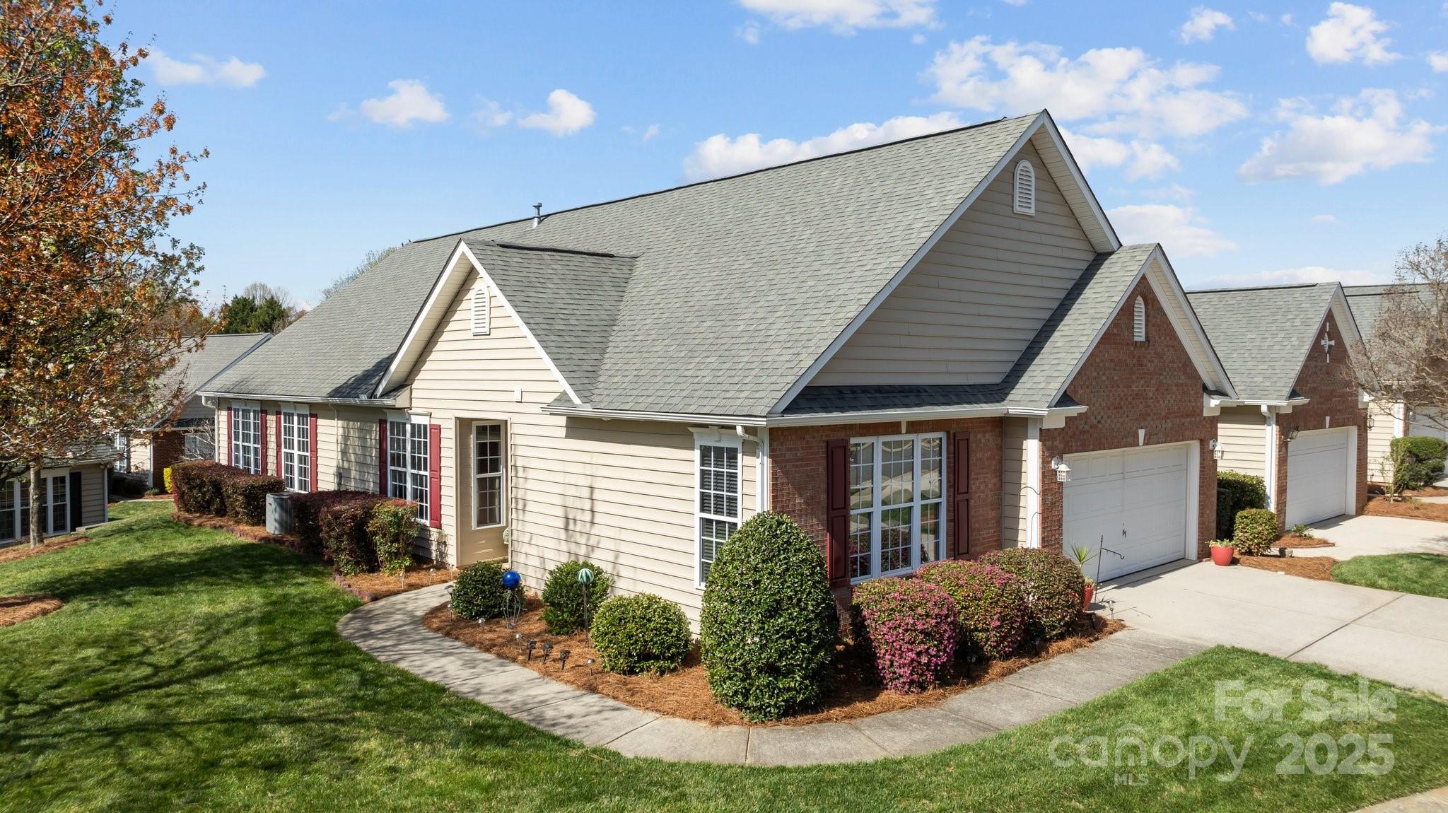 1668 Onyx Ridge, Unit 116 Fort Mill, SC 29708 - Photo 19 of 20 a view of house with a yard and potted plants