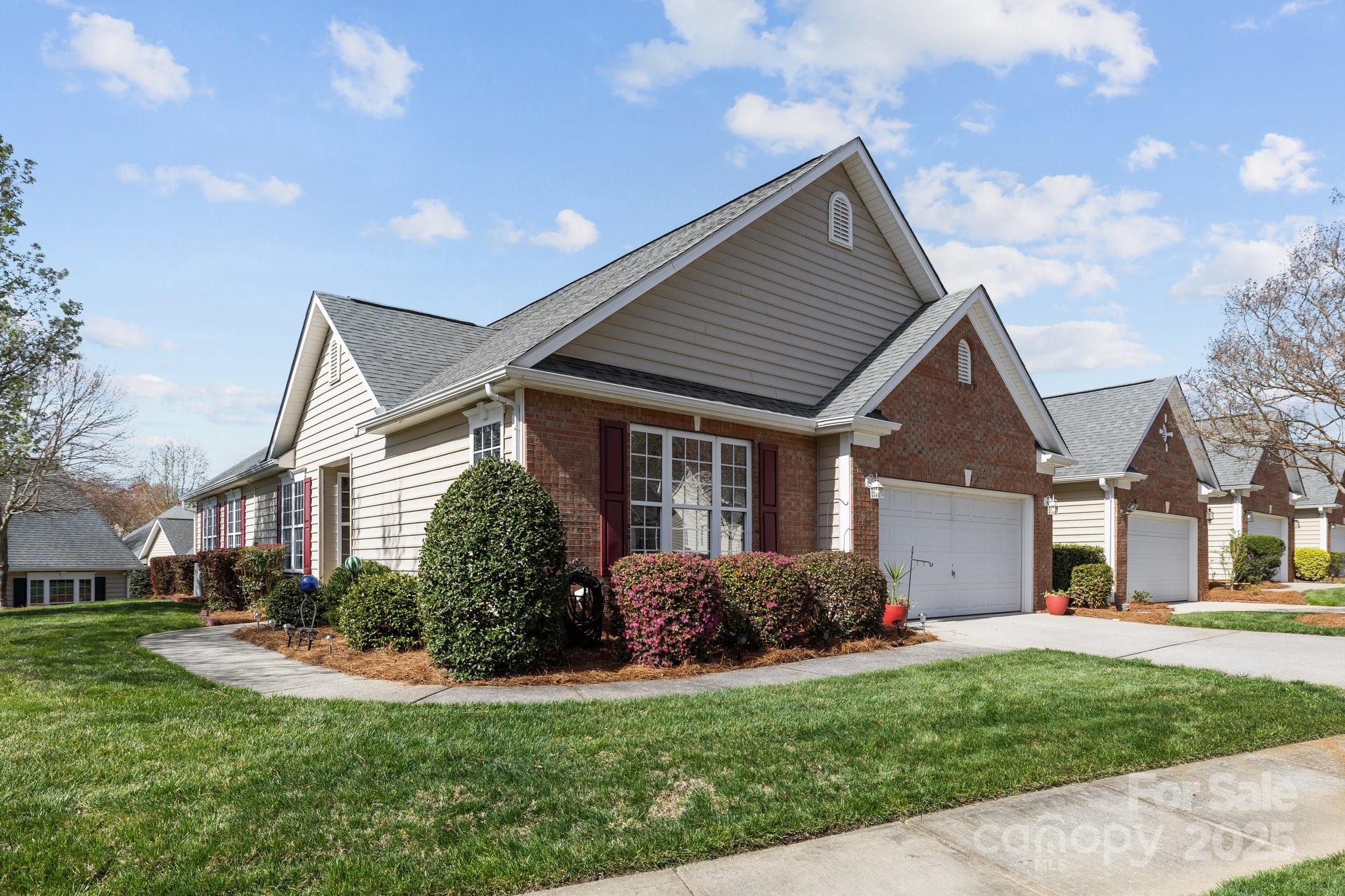1668 Onyx Ridge, Unit 116 Fort Mill, SC 29708 - Photo 2 of 20 a front view of a house with a yard