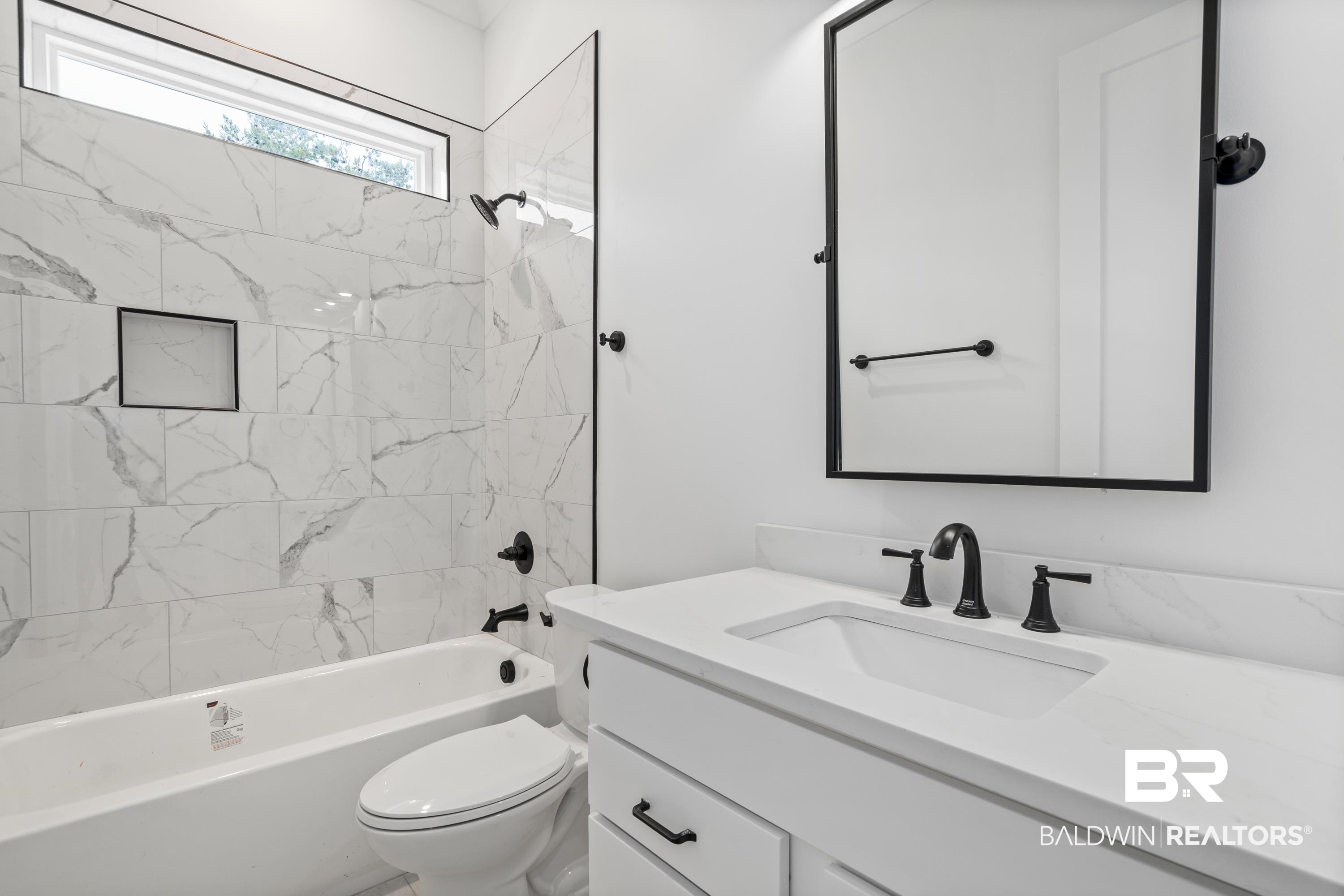 30650 Ono N Loop West Orange Beach, AL 36561 - Photo 26 of 38 Full bathroom with vanity, toilet, and bathing tub / shower combination