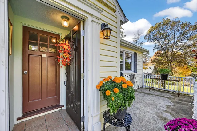 a front view of a house with a flower garden