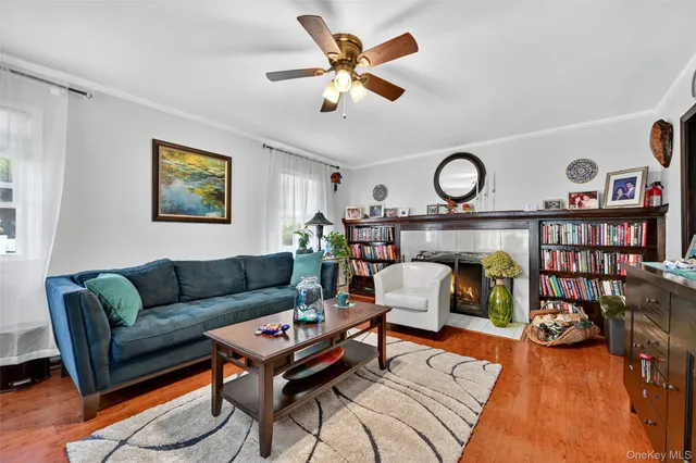a living room with furniture a rug and a wall painting